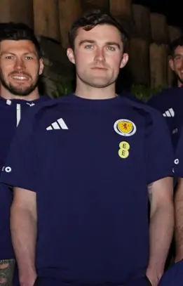 Scott McKenna stood behind John Souttar indoors, March 2026.
