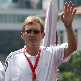 Kenny Dalglish waving on a bus in 2009