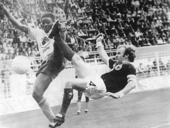 Maku Mayanga of Zaire & Billy Bremner of Scotland at 1974 World Cup.