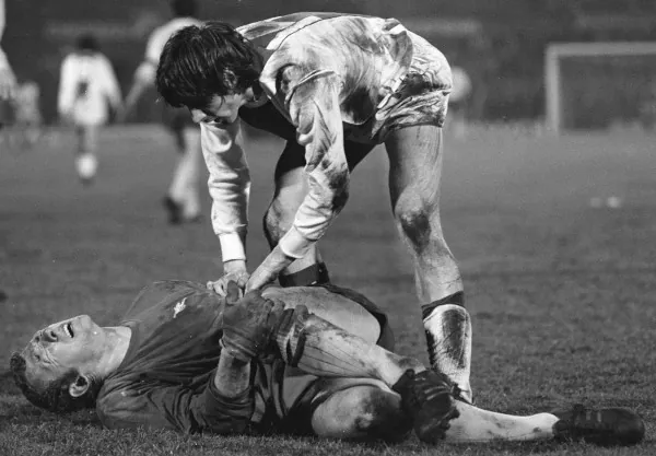 Bob Wilson injured attended to by Johan Cruyff