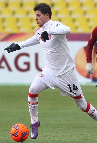 Kevin Mirallas running with the ball at his feet for Olympiacos